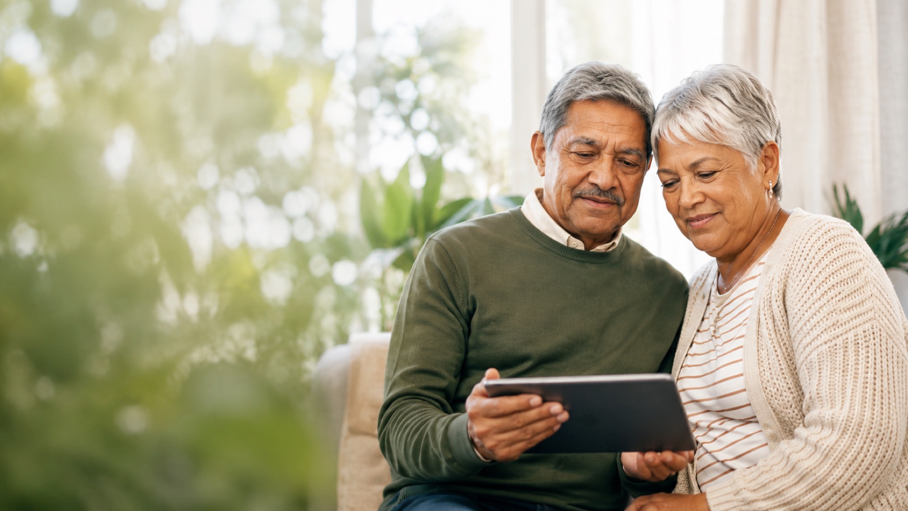 An older couple looking at documents together at home.