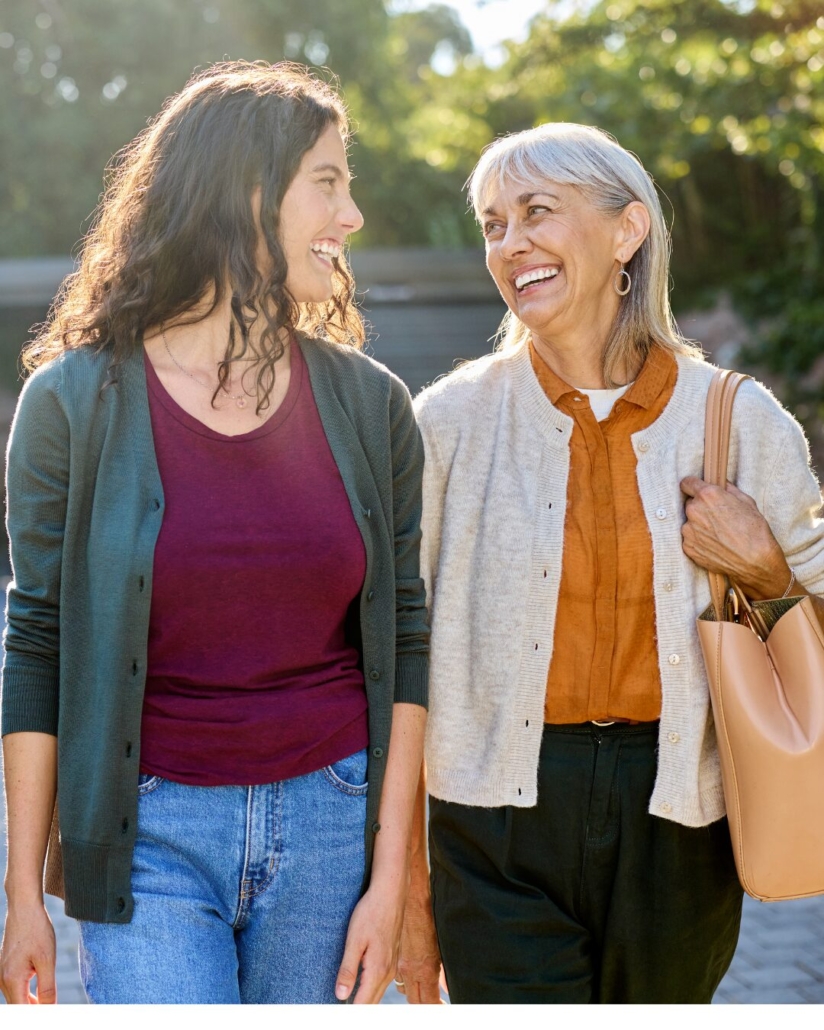 Two women laughing together outdoors